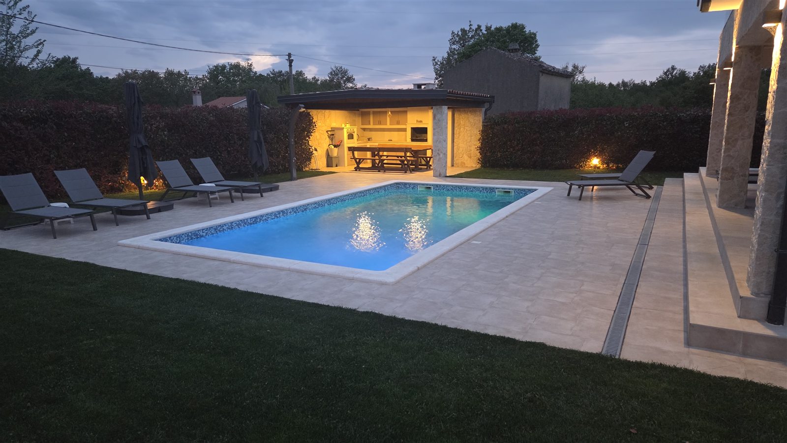 Private swimming pool and sun loungers in the garden